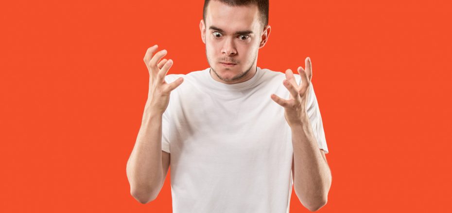 emotional angry man on studio background. Emotional, young face. male half-length portrait. Human emotions, facial expression concept. Trendy colors